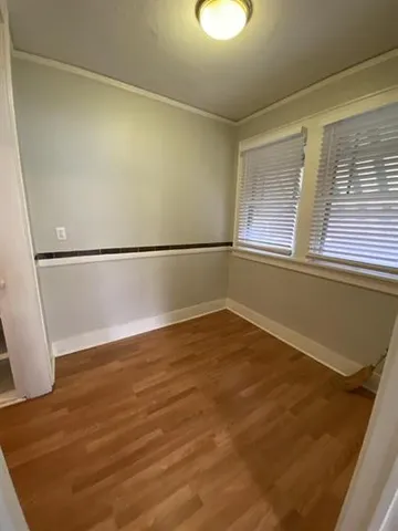 a view of a room with water heater and wooden door