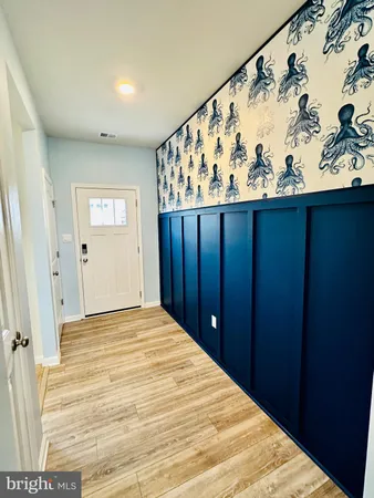 a view of a bedroom with wooden floor and cabinet