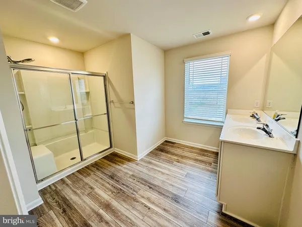 a view of a bathroom with a sink and a shower