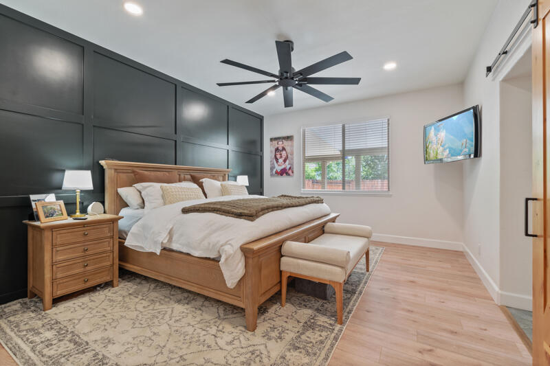 5470 Weatherby Court Reno, NV 89523 - Photo 13 of 33 a bedroom with a bed and a chandelier