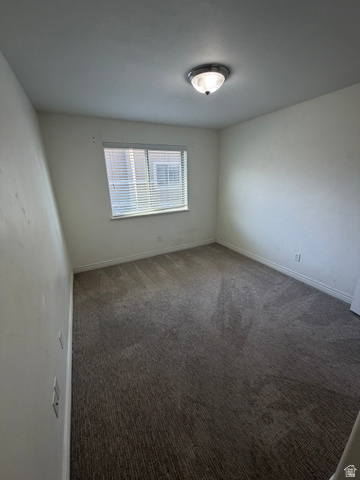 909 South Main Street, Unit F Layton, UT 84041 - Photo 6 of 20 Room featuring a neutral carpet, white walls, and a window with horizontal blinds