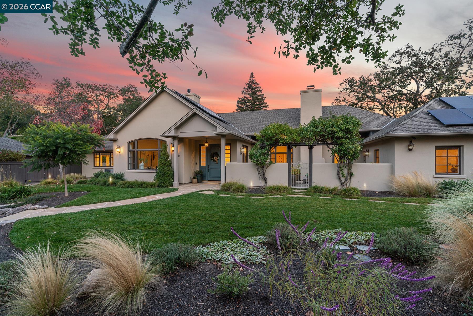 a front view of a house with a garden