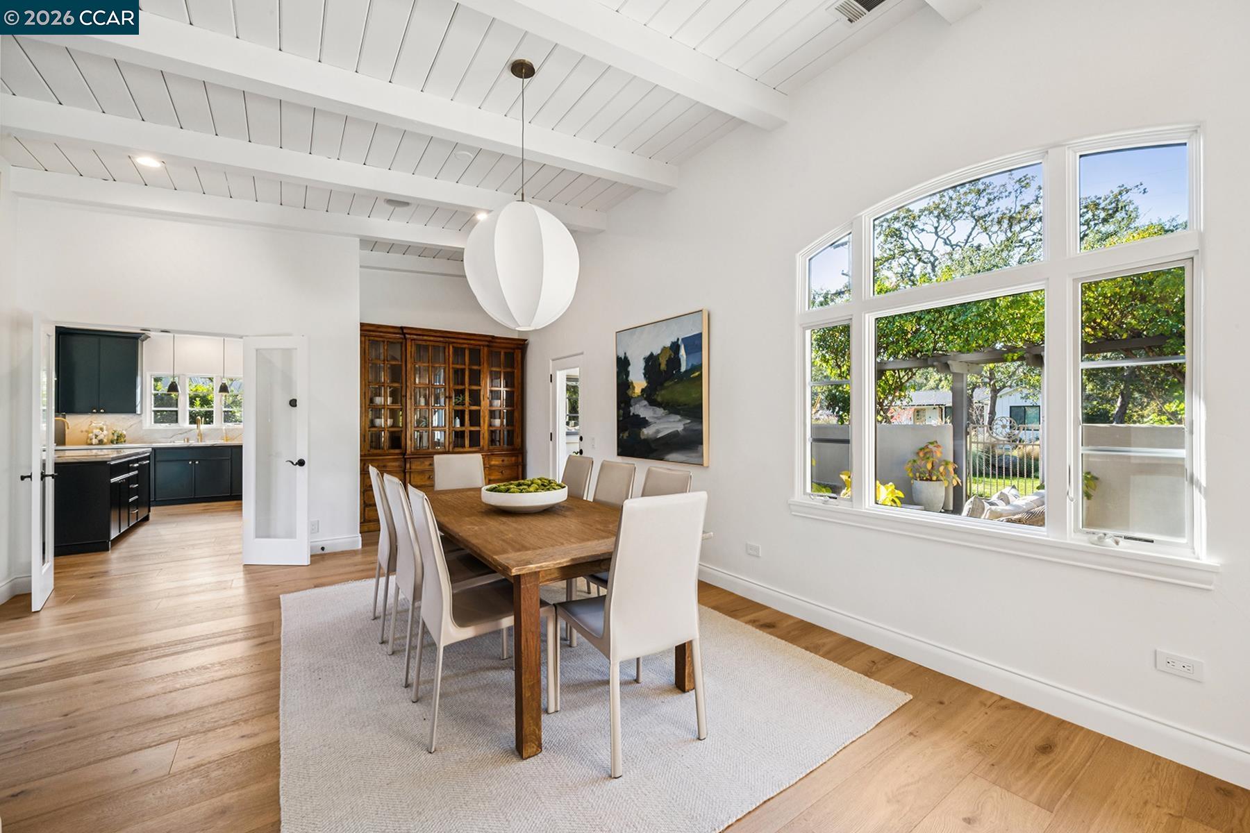 910 Carl Road Lafayette, CA 94549 - Photo 18 of 48 a dining room with wooden floor a chandelier a wooden table and chairs
