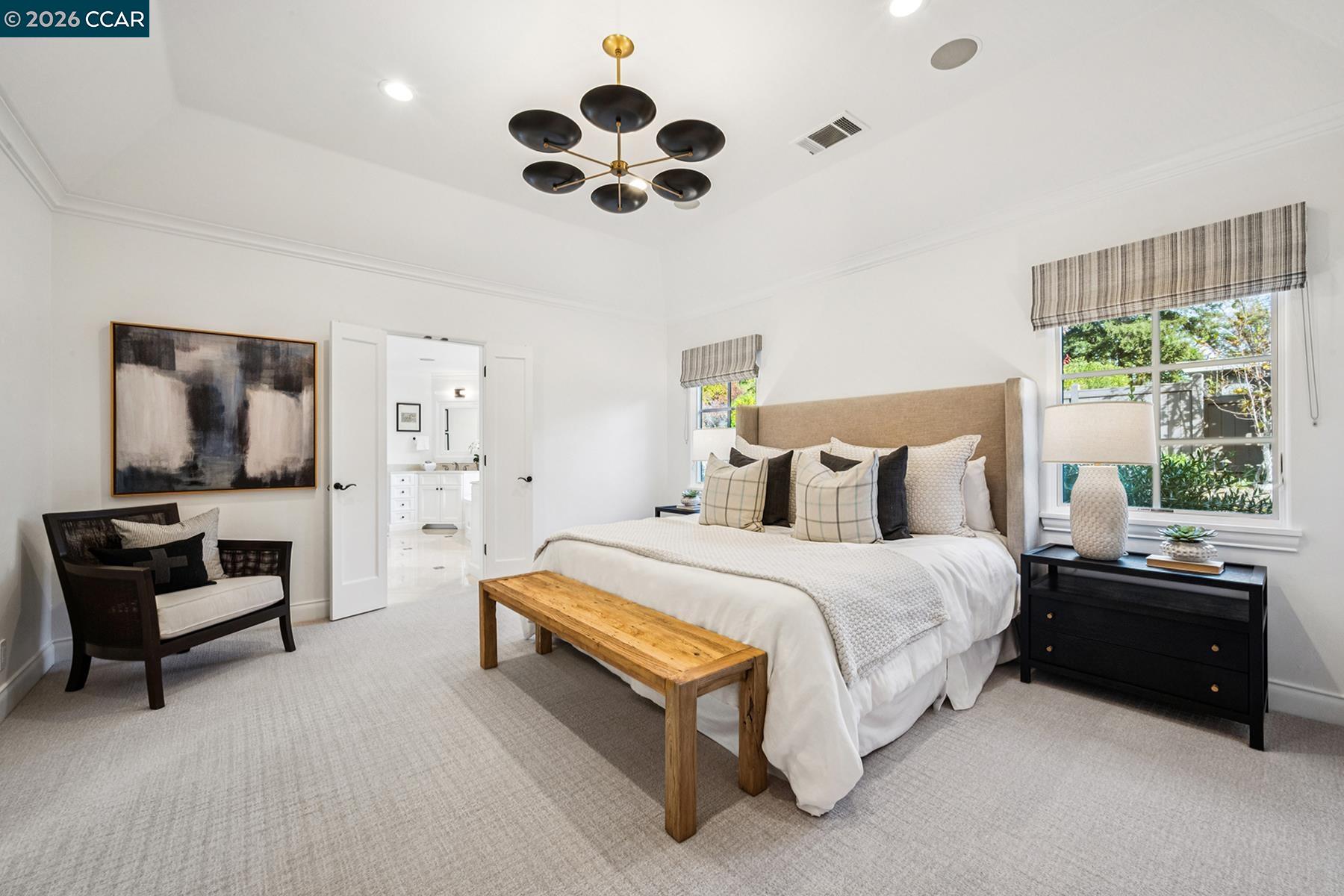 910 Carl Road Lafayette, CA 94549 - Photo 31 of 48 a spacious bedroom with a bed and a chandelier