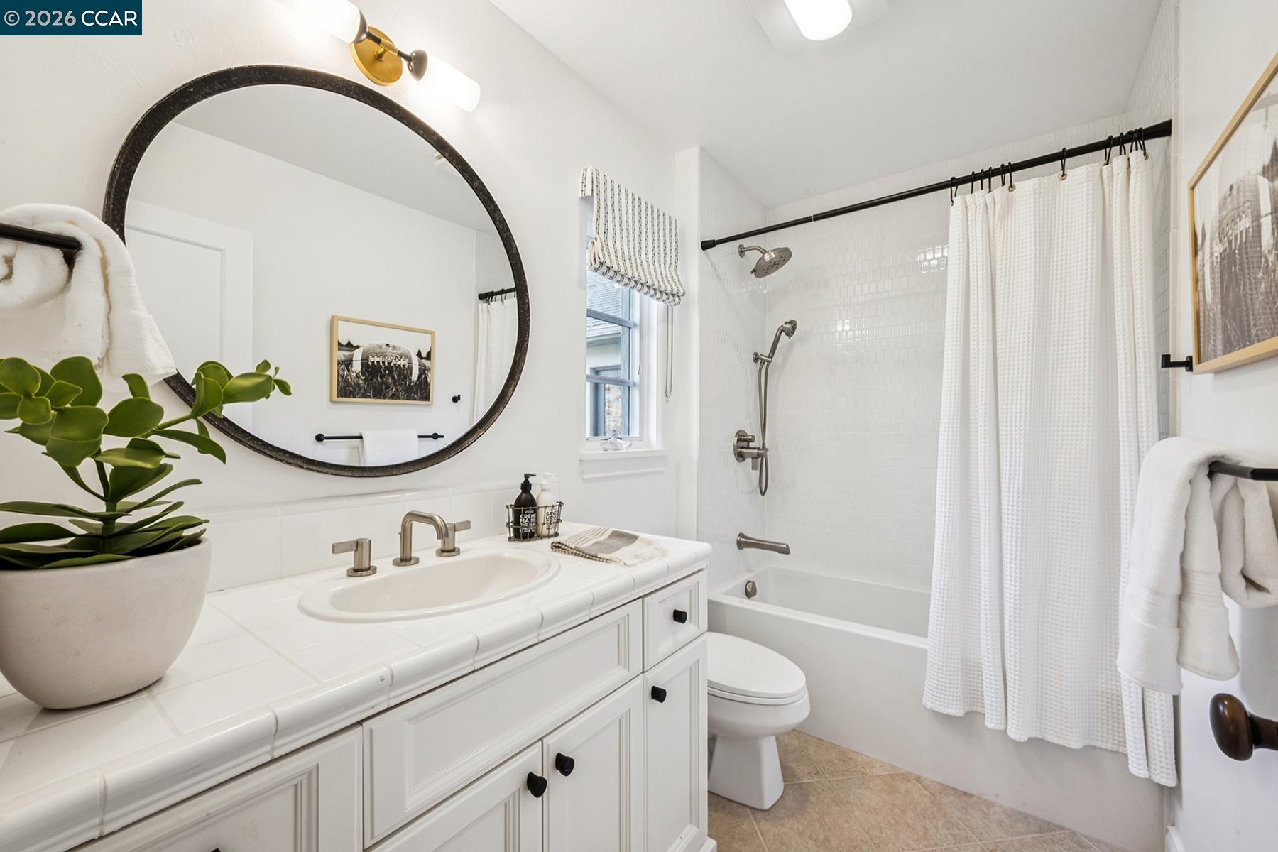 910 Carl Road Lafayette, CA 94549 - Photo 38 of 48 a bathroom with a granite countertop sink a toilet and a mirror