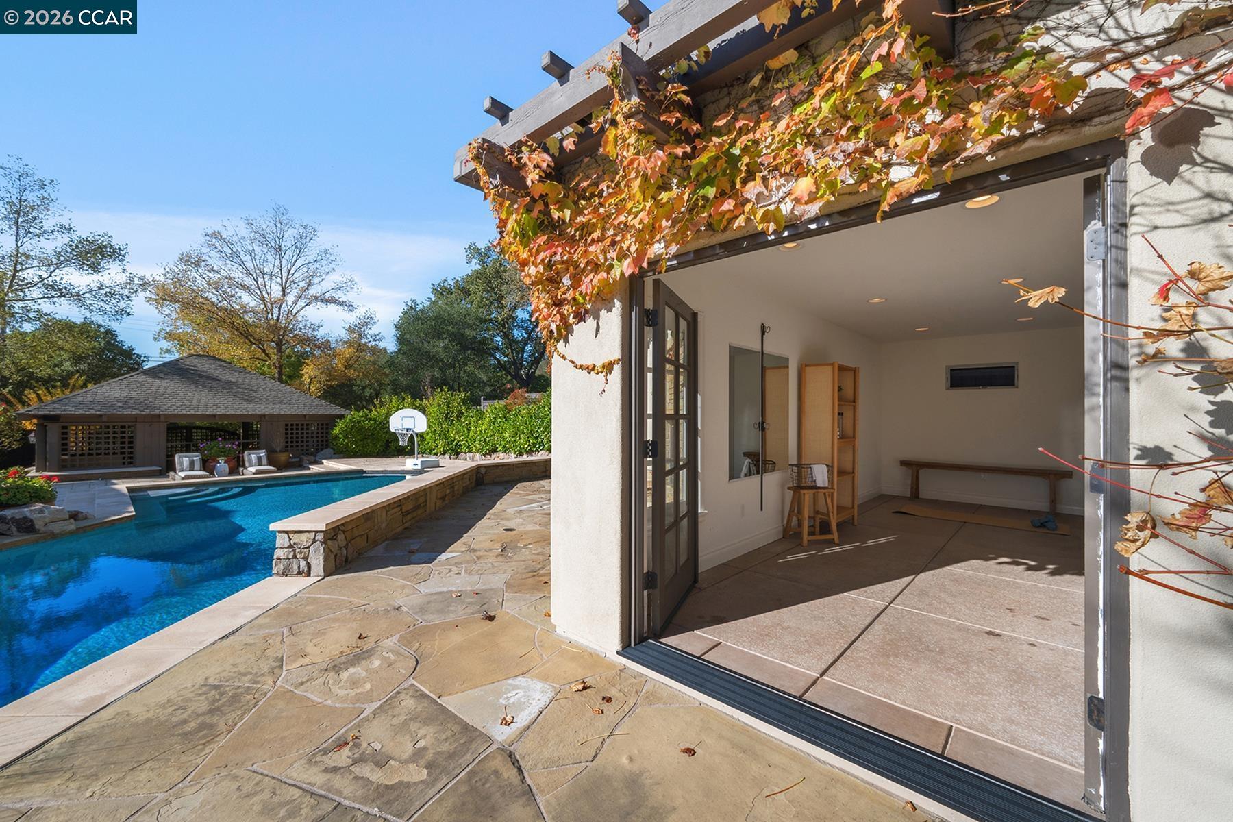 910 Carl Road Lafayette, CA 94549 - Photo 42 of 48 a view of a patio with a table and chairs under an umbrella