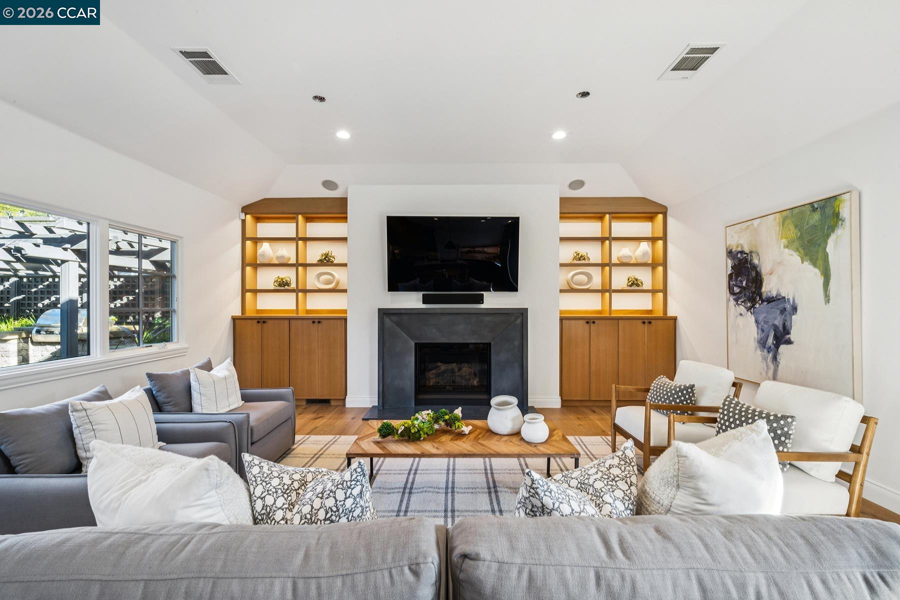 910 Carl Road Lafayette, CA 94549 - Photo 9 of 48 a living room with furniture a fireplace and a flat screen tv