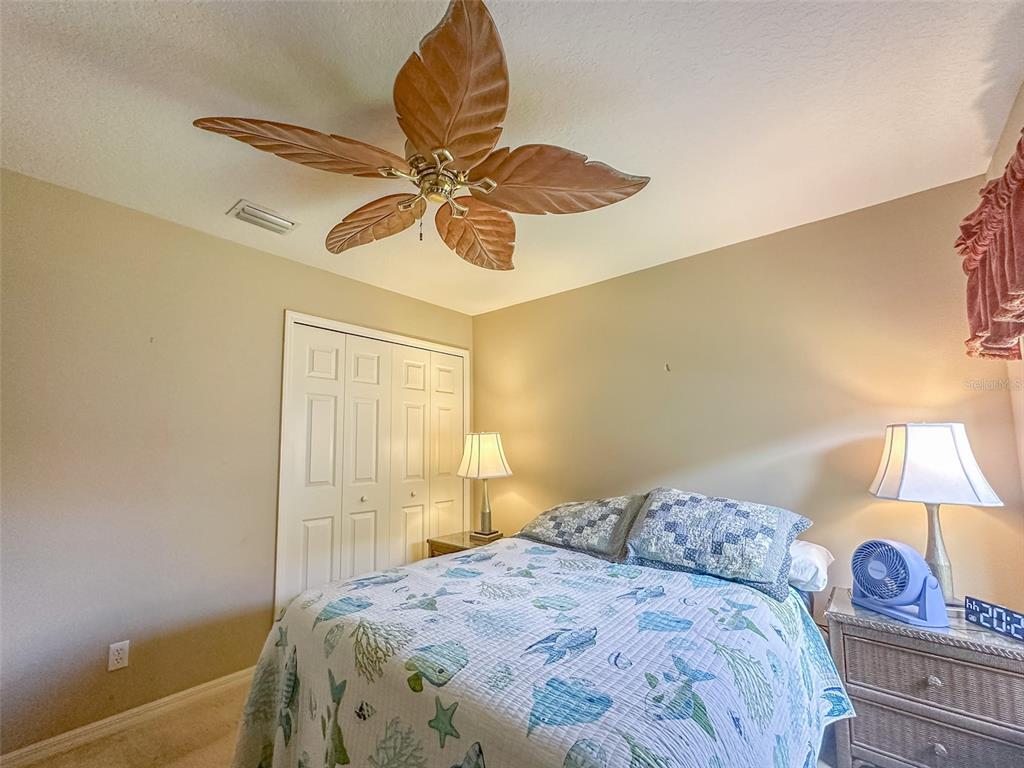 5300 Treasure View Way Leesburg, FL 34748 - Photo 15 of 47 a bedroom with a bed and a chandelier