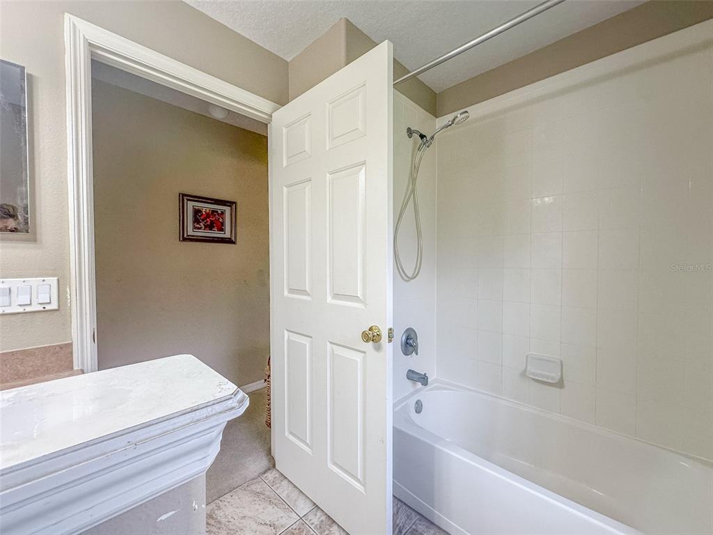 5300 Treasure View Way Leesburg, FL 34748 - Photo 19 of 47 a bathroom with a bathtub and a shower