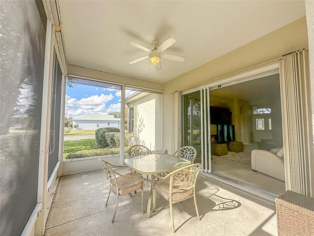 5300 Treasure View Way Leesburg, FL 34748 - Photo 21 of 47 a dining room with furniture and a floor to ceiling window
