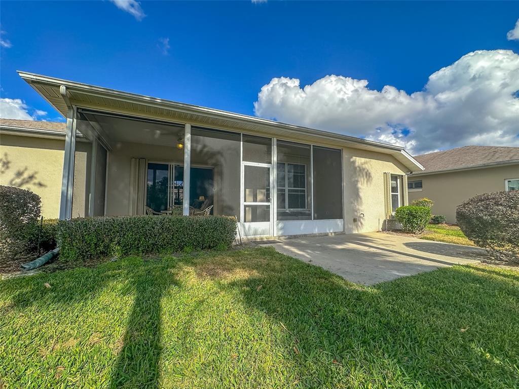 5300 Treasure View Way Leesburg, FL 34748 - Photo 23 of 47 a view of a house with backyard and porch