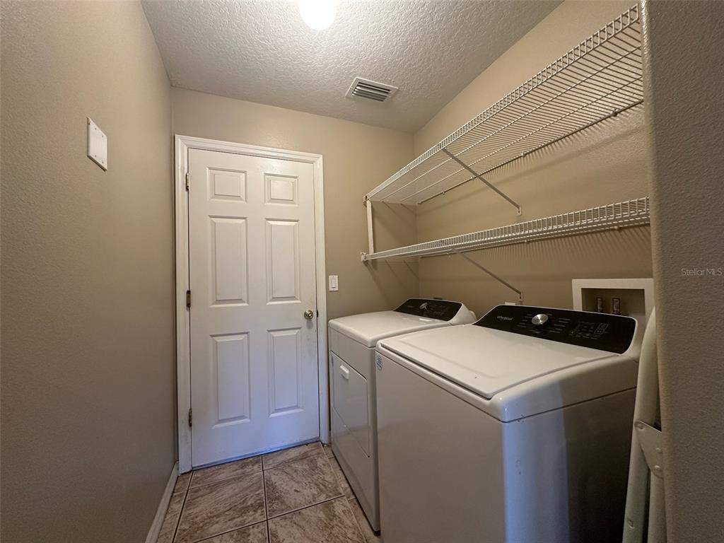 5300 Treasure View Way Leesburg, FL 34748 - Photo 24 of 47 a utility room with dryer and washer