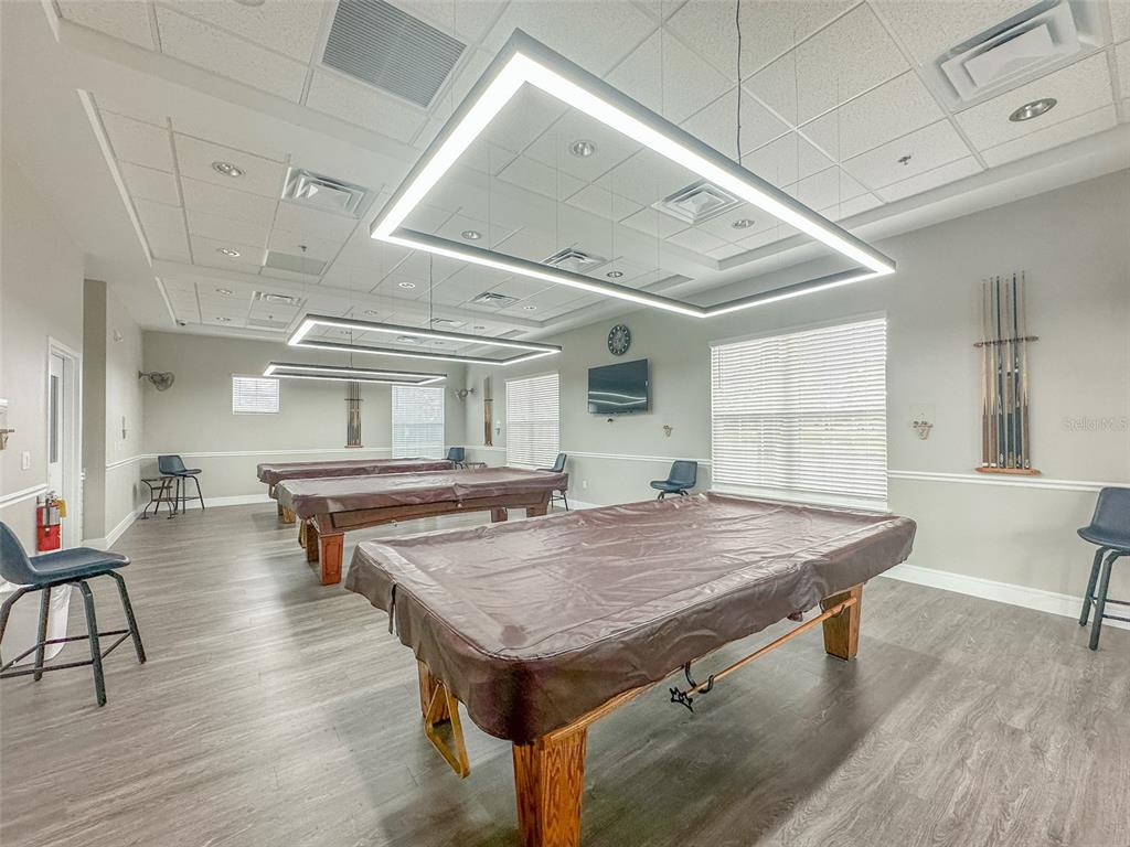 5300 Treasure View Way Leesburg, FL 34748 - Photo 31 of 47 a kitchen with a table chairs and wooden floor