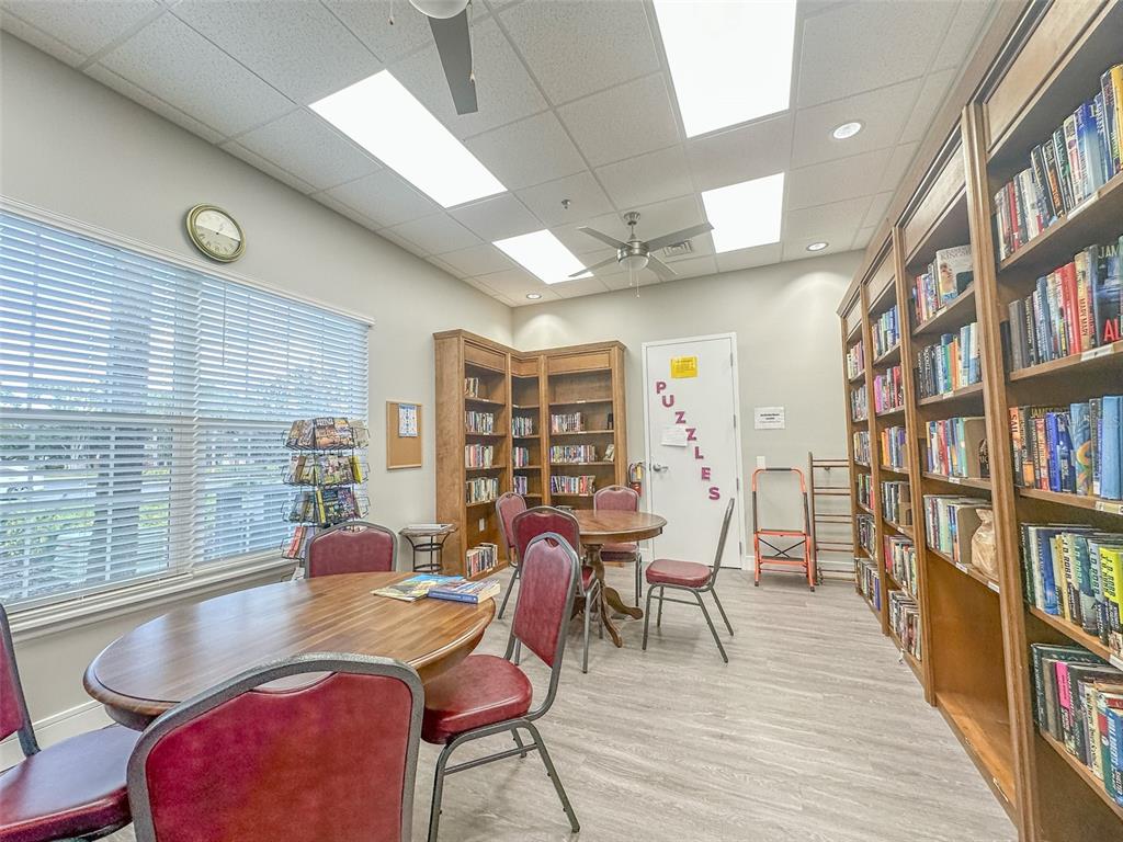 5300 Treasure View Way Leesburg, FL 34748 - Photo 32 of 47 a view of a livingroom with furniture and a book shelf