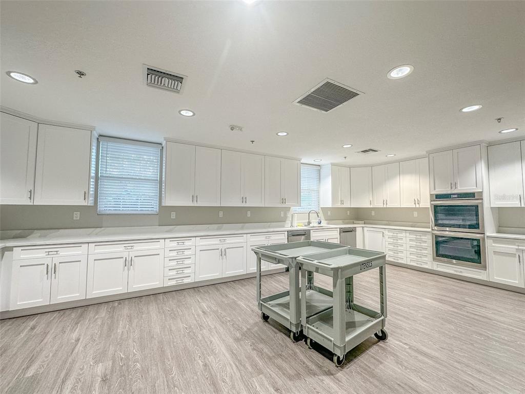 5300 Treasure View Way Leesburg, FL 34748 - Photo 34 of 47 a kitchen with a cabinets and wooden floor
