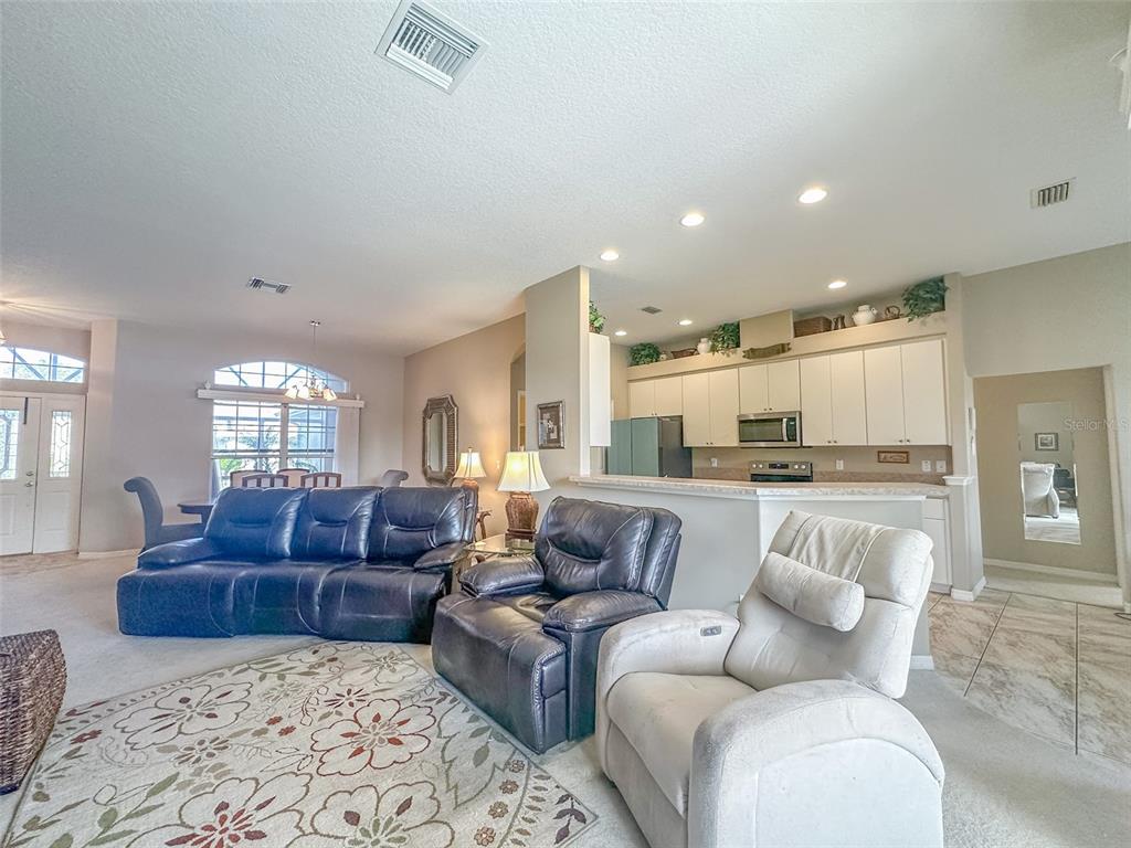 5300 Treasure View Way Leesburg, FL 34748 - Photo 5 of 47 a living room with furniture and a large window