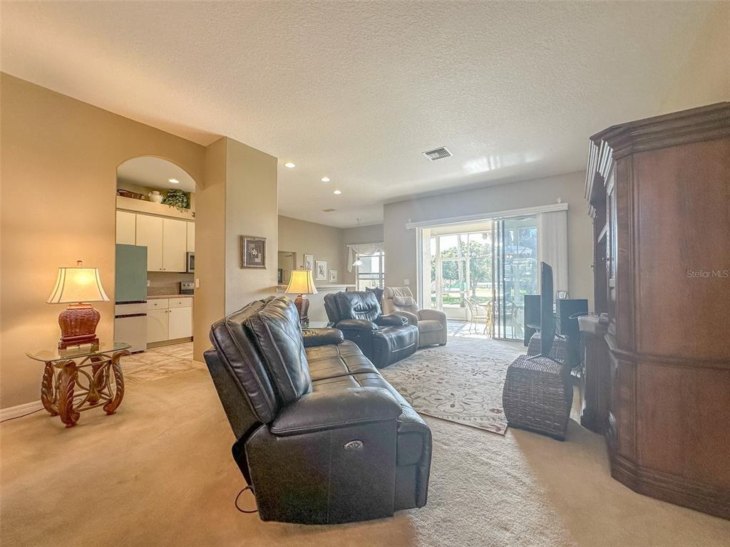5300 Treasure View Way Leesburg, FL 34748 - Photo 6 of 47 a living room with furniture and a large window