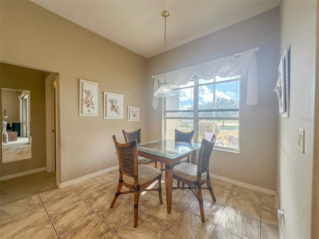 5300 Treasure View Way Leesburg, FL 34748 - Photo 10 of 47 a view of a dining room with furniture and window