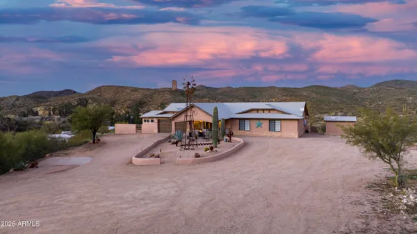 a view of a house with a yard and a garden
