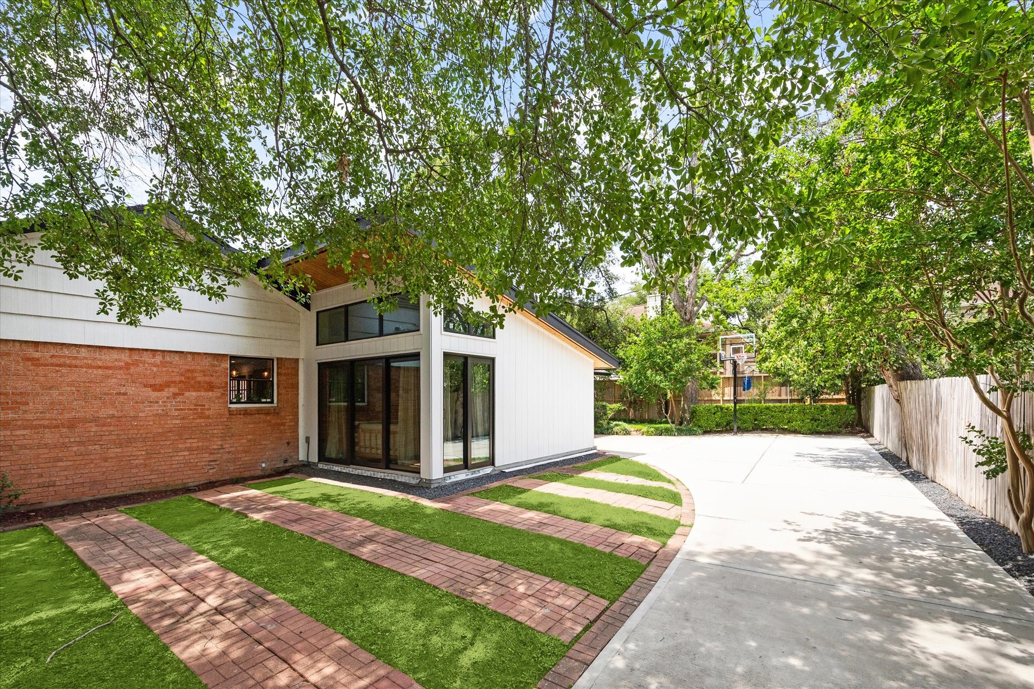 1902 Chimney Rock Road Houston, TX 77057 - Photo 32 of 32 From the driveway leading through the gate is the very recently added 4th bedroom/Office/Study as shown in an interior photo That wing can be another Primary Bedroom/Office/Study with full bathroom.
