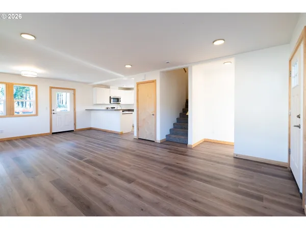 a view of empty room with wooden floor