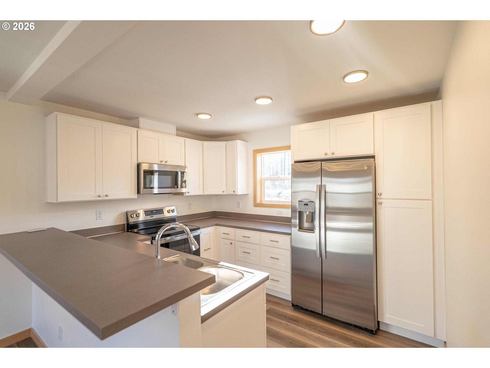 51702 Rose Street Blue River, OR 97413 - Photo 5 of 17 a kitchen with stainless steel appliances a refrigerator sink and microwave