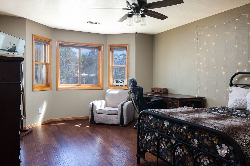 400 Dominy Road Lone Pine, CA 93545 - Photo 14 of 33 a bedroom with a bed and wooden floor