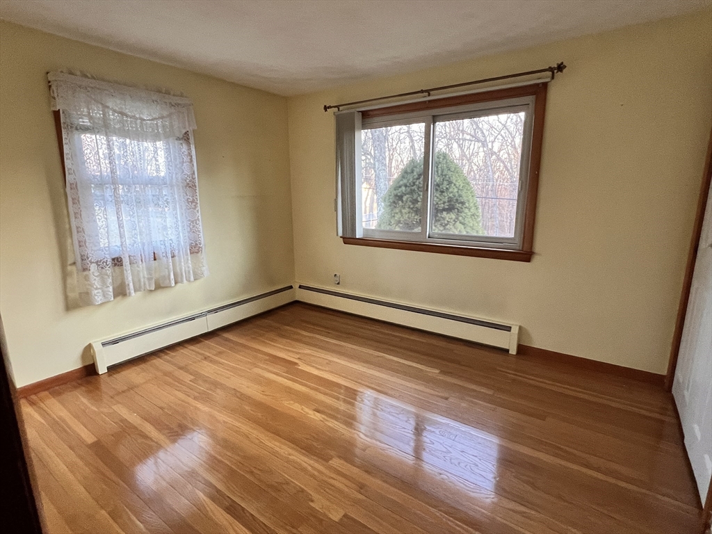 31 Upper Gore Road Webster, MA 01570 - Photo 14 of 33 a view of an empty room with wooden floor and a window