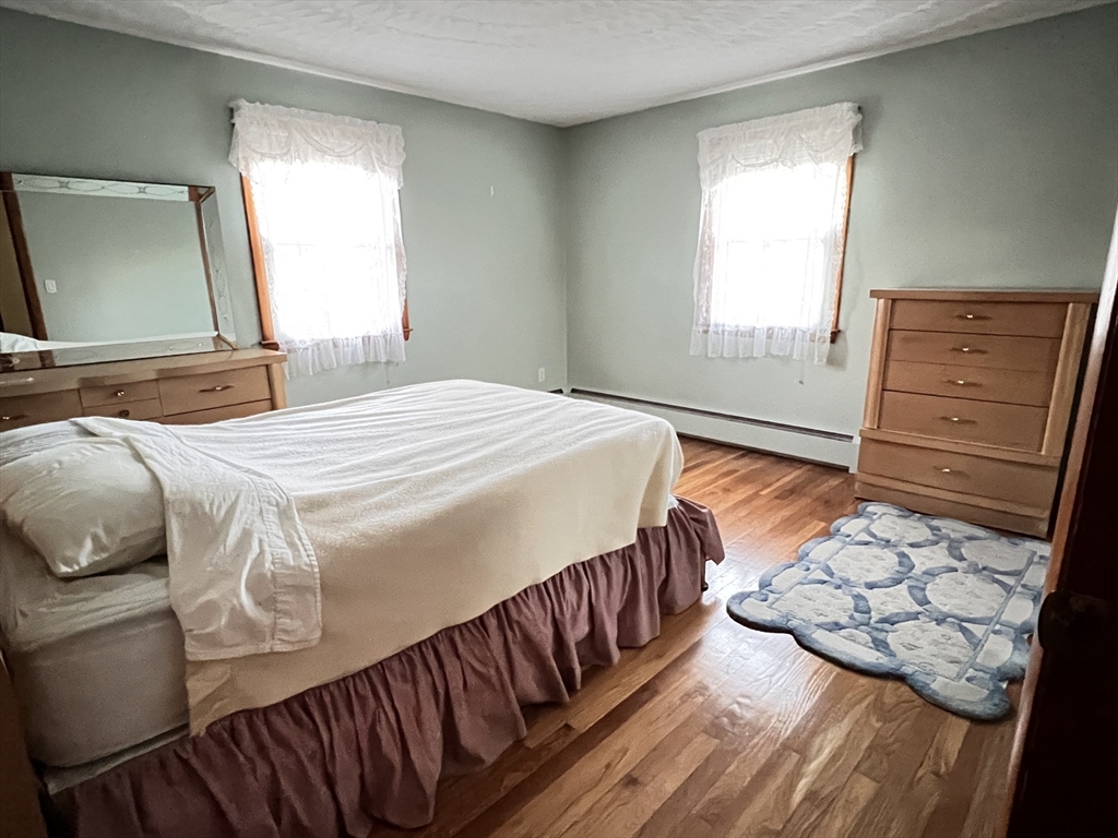 31 Upper Gore Road Webster, MA 01570 - Photo 19 of 33 a bedroom with a bed and wooden floor