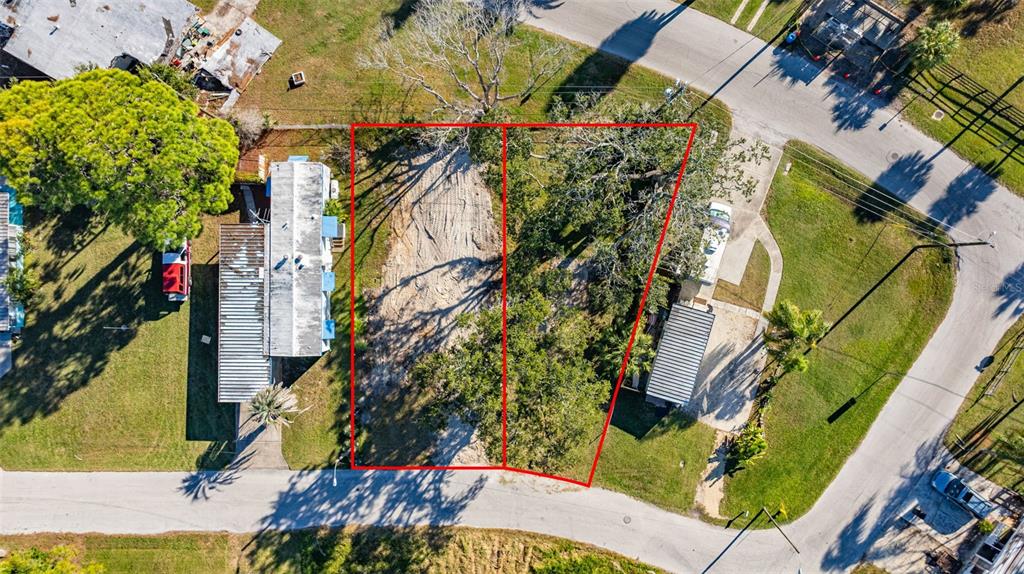 4836 Snug Harbor Road New Port Richey, FL 34652 - Photo 14 of 16 an aerial view of a house with a yard