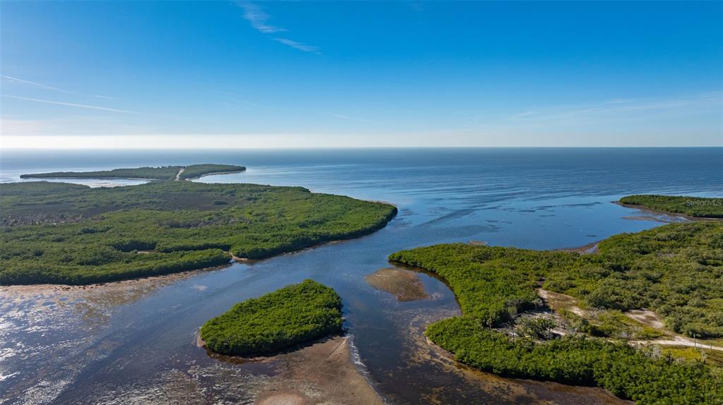 4836 Snug Harbor Road New Port Richey, FL 34652 - Photo 16 of 16 a view of a lake with a yard