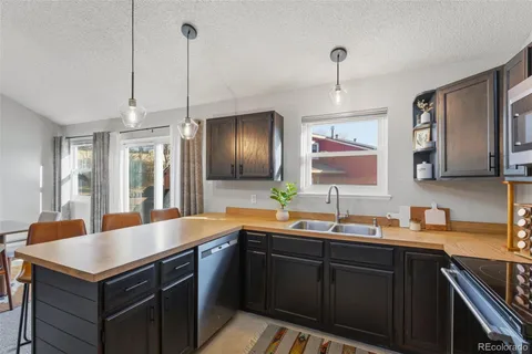a kitchen with sink and refrigerator