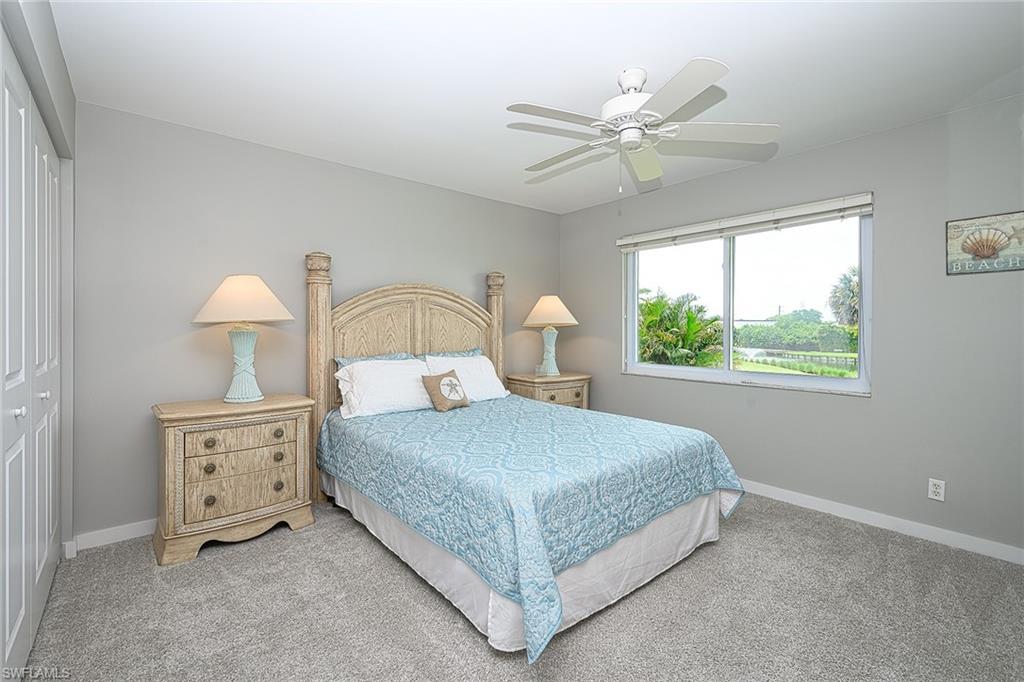231 Memory Lane, Unit 4 Naples, FL 34112 - Photo 19 of 33 Guest bedroom with golf course, water views