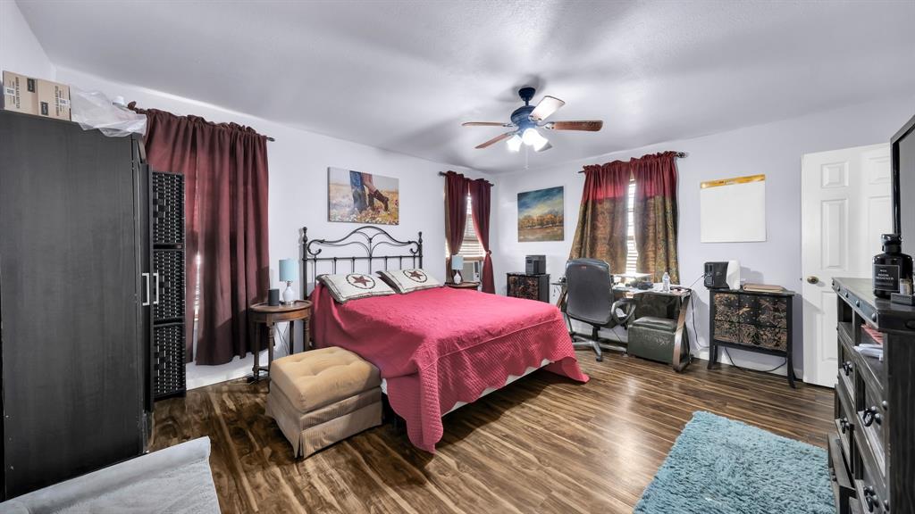 11500 Bowden Road Lipan, TX 76462 - Photo 23 of 32 Bedroom with ceiling fan and dark hardwood / wood-style flooring