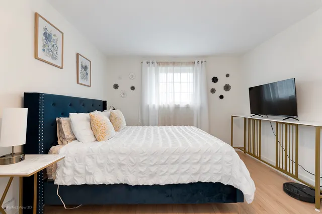 a bedroom with a bed and a flat screen tv