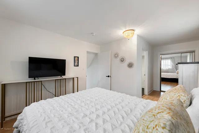 a bedroom with a bed and a flat screen tv