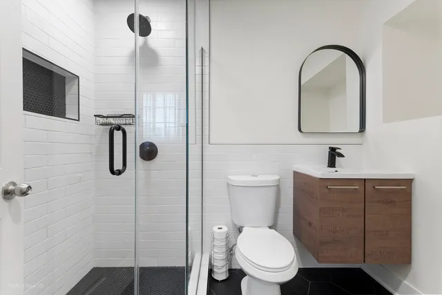 a bathroom with a toilet sink and shower