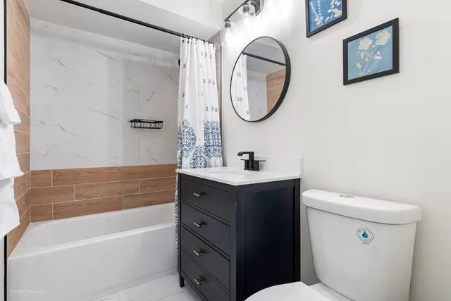 a bathroom with a sink a mirror a toilet and a bathtub