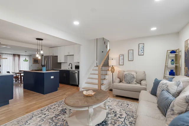 a living room with furniture and kitchen view