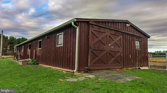 a view of backyard with barbeque grill potted plants and wooden fence