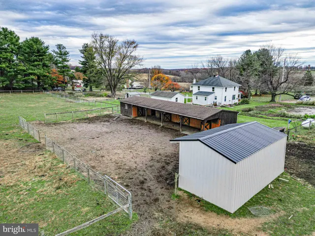 a view of a house with yard and sitting area