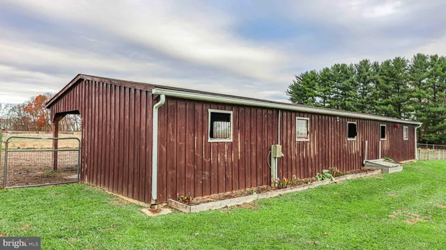 a view of backyard with potted plants and wooden fence