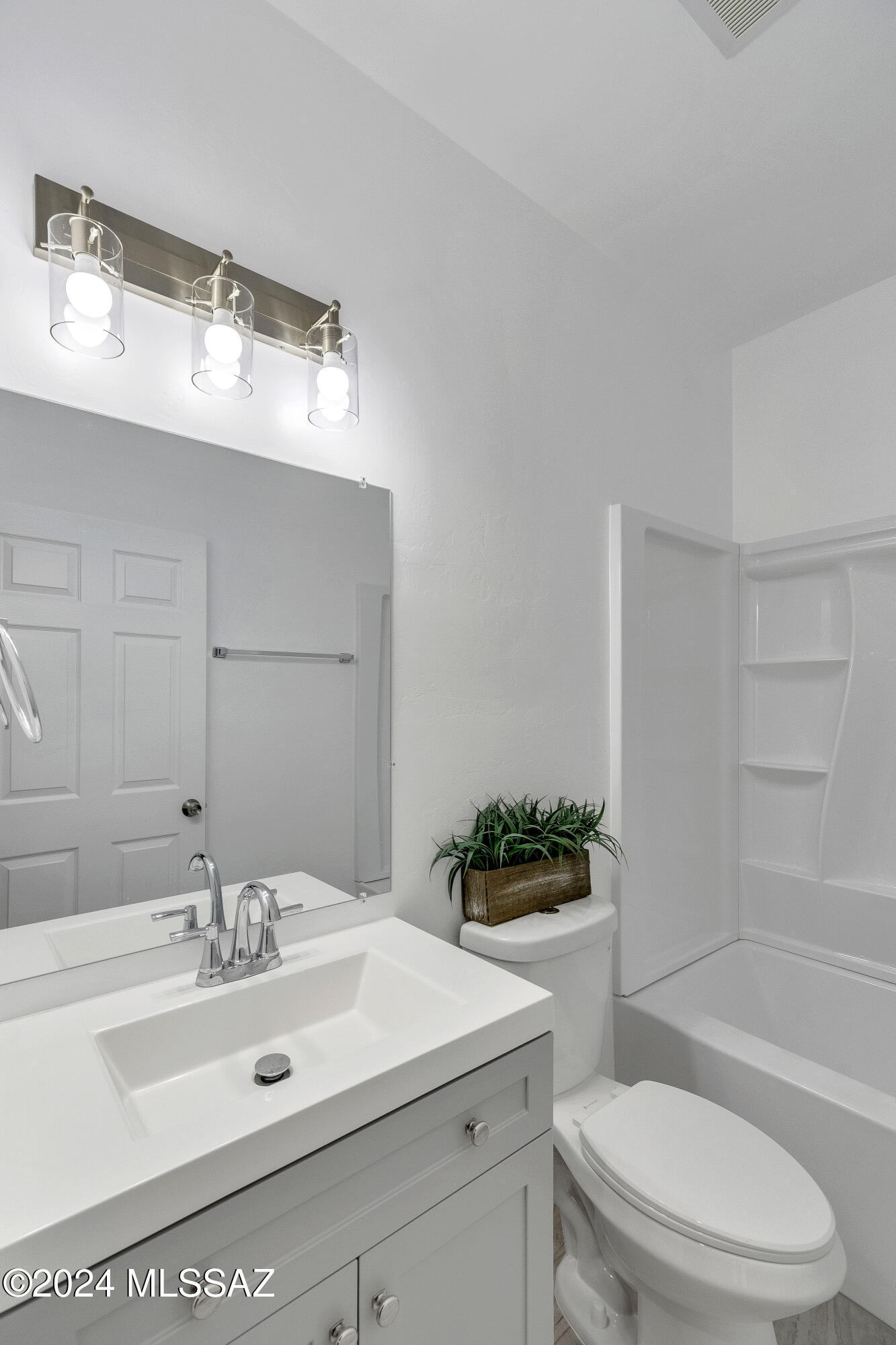 221 Paseo Mascota Rio Rico, AZ 85648 - Photo 26 of 45 a bathroom with a sink vanity mirror and toilet