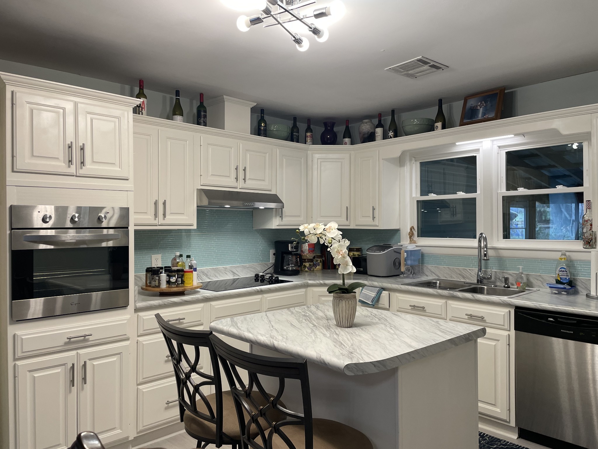 202 Shasteen Street Estill Springs, TN 37330 - Photo 11 of 35 a kitchen with stainless steel appliances kitchen island granite countertop a sink and cabinets