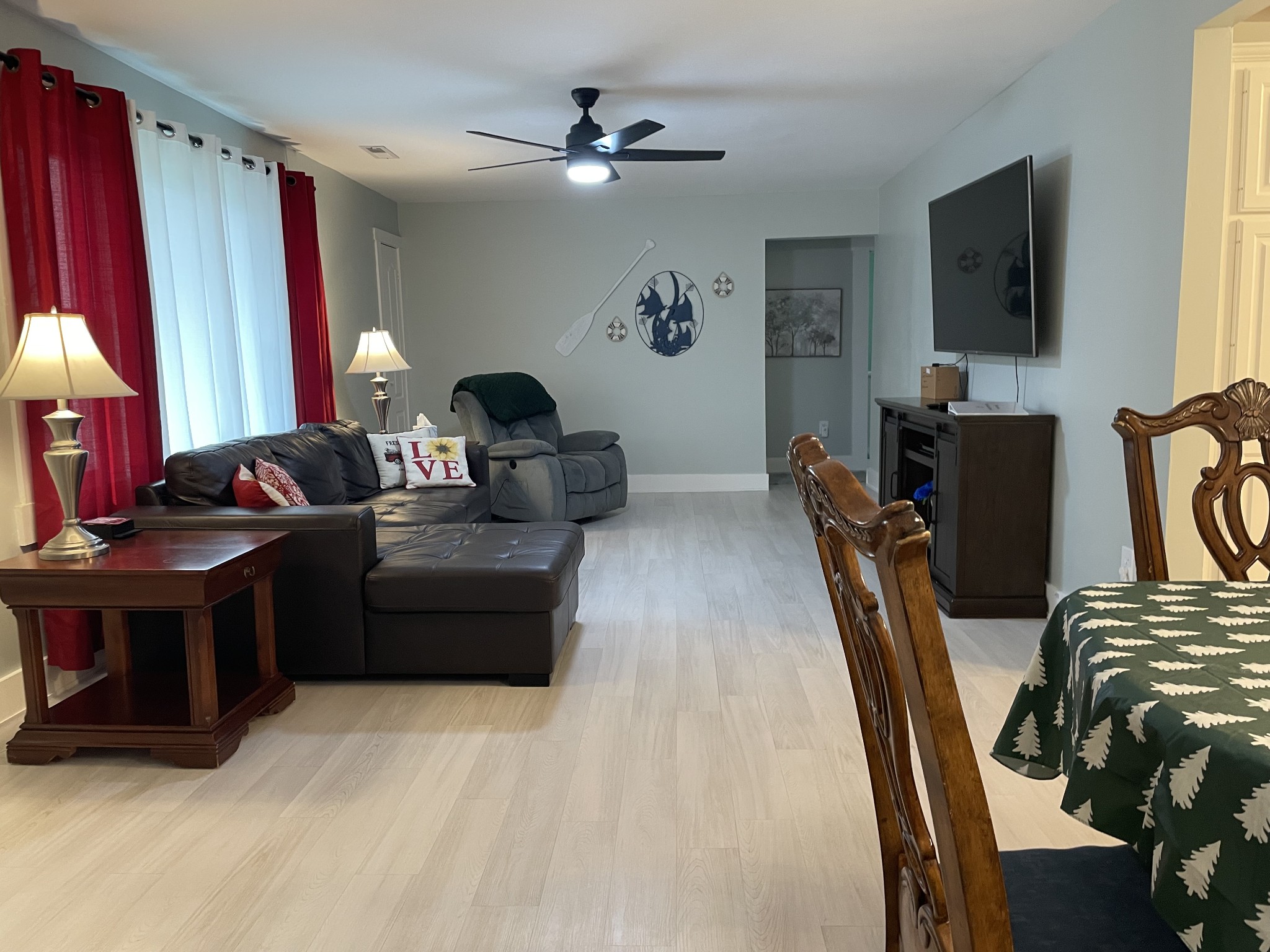 202 Shasteen Street Estill Springs, TN 37330 - Photo 3 of 35 a living room with furniture a flat screen tv and a fireplace