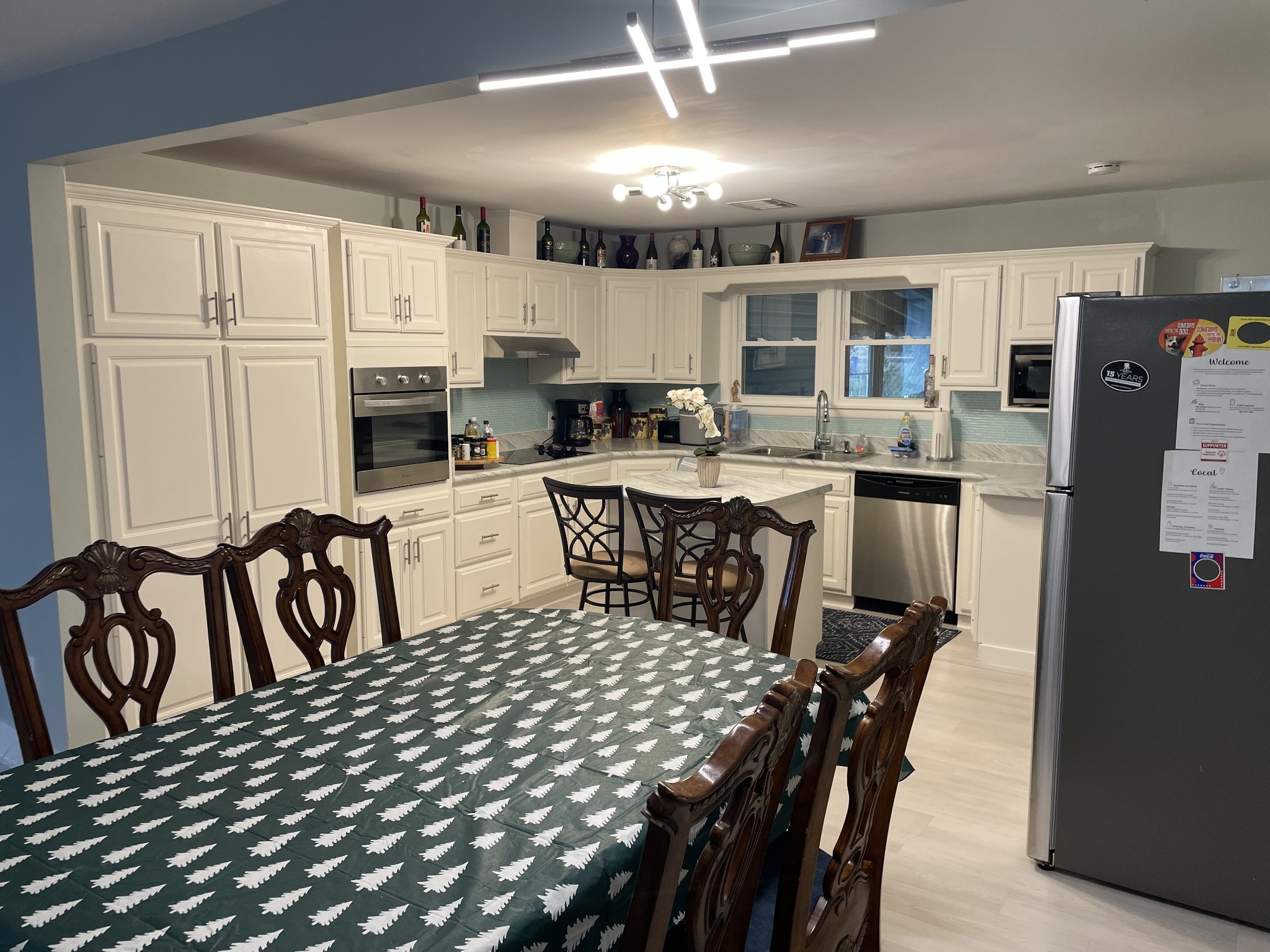 202 Shasteen Street Estill Springs, TN 37330 - Photo 8 of 35 a kitchen with a table chairs refrigerator and cabinets