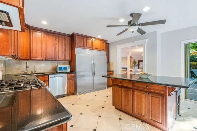 a kitchen with stainless steel appliances a sink a counter space cabinets and appliances
