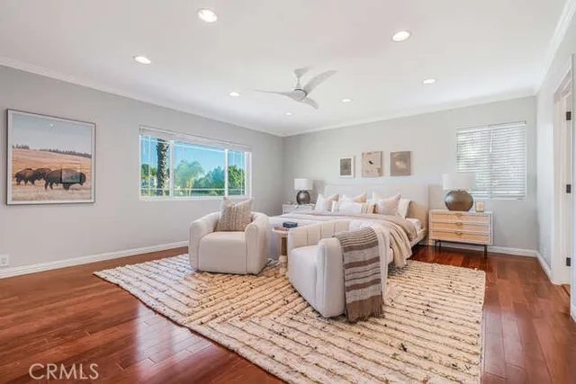 a bedroom with furniture and wooden floor