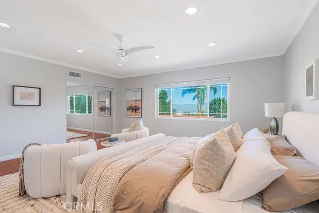 a bedroom with a large bed and a window