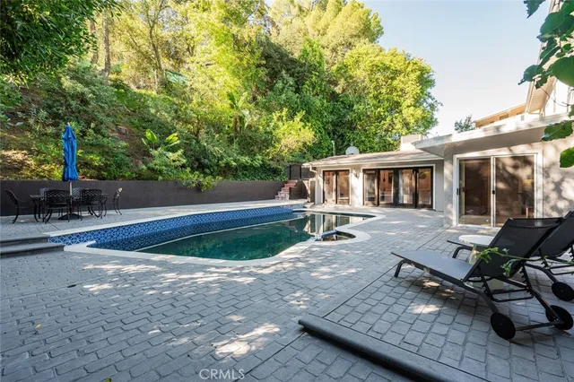 a view of a house with backyard sitting area and sitting area